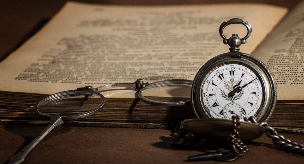 A stopwatch resting against an open book