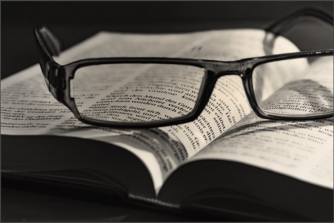 pexels-photo-267549 black eyeglasses placed on white book